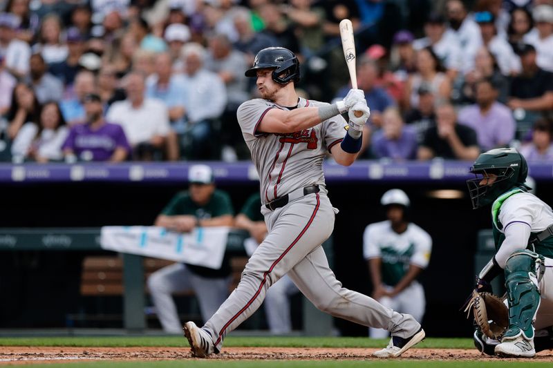 Aug 10, 2024; Denver, Colorado, USA; Atlanta Braves catcher Sean Murphy (12) hits a single in the third inning against the Colorado Rockies at Coors Field. Mandatory Credit: Isaiah J. Downing-USA TODAY Sports