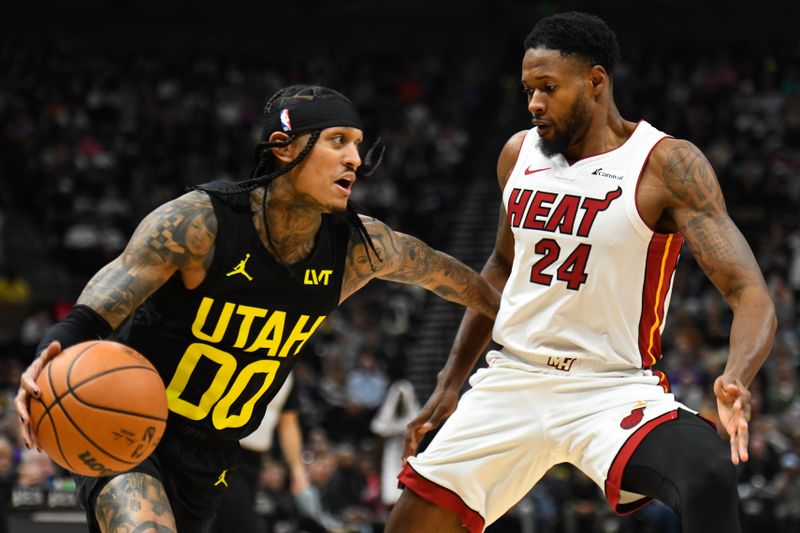 SALT LAKE CITY, UTAH - DECEMBER 30: Jordan Clarkson #00 of the Utah Jazz drives into Haywood Highsmith #24 of the Miami Heat during the first half of a game at Delta Center on December 30, 2023 in Salt Lake City, Utah. NOTE TO USER: User expressly acknowledges and agrees that, by downloading and or using this photograph, User is consenting to the terms and conditions of the Getty Images License Agreement. (Photo by Alex Goodlett/Getty Images)