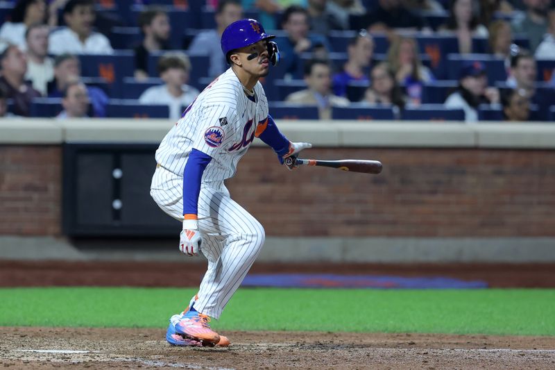 Jun 12, 2024; New York City, New York, USA; New York Mets third baseman Mark Vientos (27) follows through on an RBI single against the Miami Marlins during the seventh inning at Citi Field. Mandatory Credit: Brad Penner-USA TODAY Sports