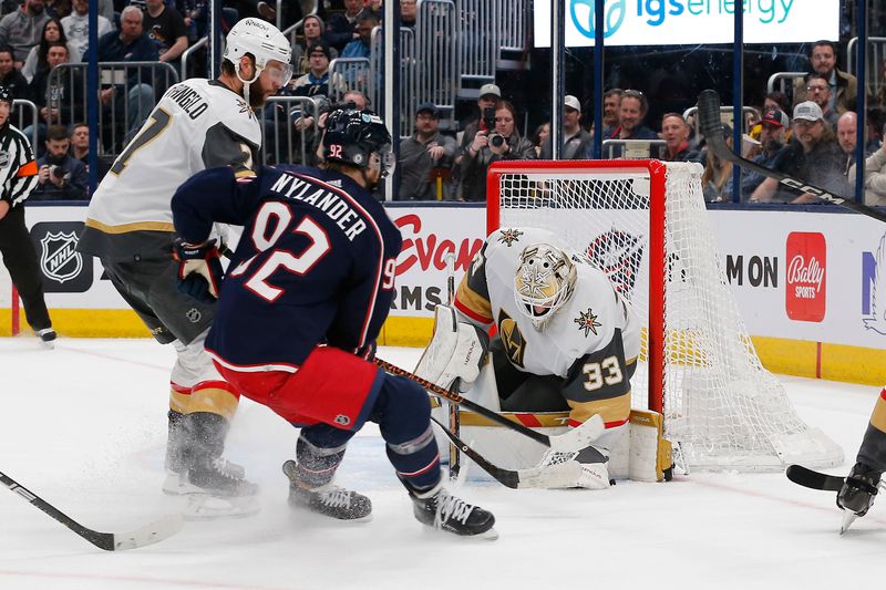 Mar 4, 2024; Columbus, Ohio, USA; Vegas Golden Knights goalie Adin Hill (33) makes a save against the Columbus Blue Jackets during the second period at Nationwide Arena. Mandatory Credit: Russell LaBounty-USA TODAY Sports