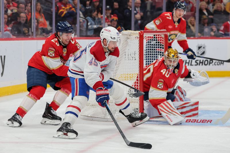 Dec 30, 2025; Sunrise, Florida, USA; Montreal Canadiens defenseman Alexandre Carrier (45) moves the puck behind the net of Florida Panthers goaltender Daniil Tarasov (40) against center Carter Verhaeghe (23) during the second period during the second period at Amerant Bank Arena. Mandatory Credit: Sam Navarro-Imagn Images
