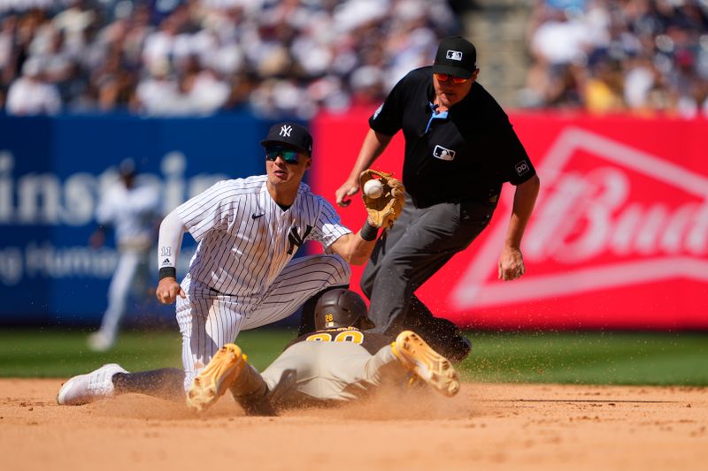 May 28, 2023; Bronx, New York, USA; San Diego Padres right fielder Jose Azocar (28) slides into second base ahead of throw to New York Yankees shortstop Anthony Volpe (11) during the seventh inning at Yankee Stadium. Mandatory Credit: Gregory Fisher-USA TODAY Sports