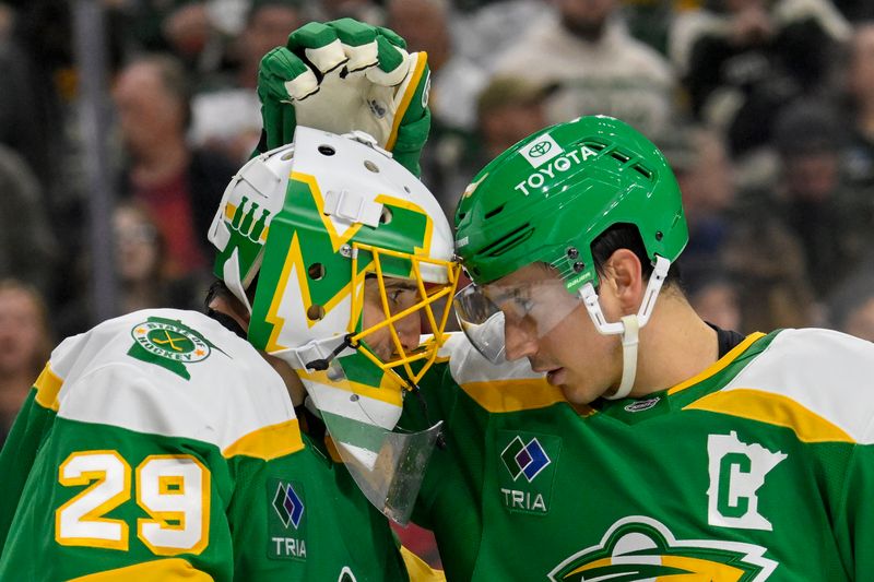 Nov 29, 2024; Saint Paul, Minnesota, USA;  Minnesota Wild goalie Marc-Andre Fleury (29) and defenseman Jared Spurgeon (46) celebrate a victory over the Chicago Blackhawks at Xcel Energy Center. Mandatory Credit: Nick Wosika-Imagn Images