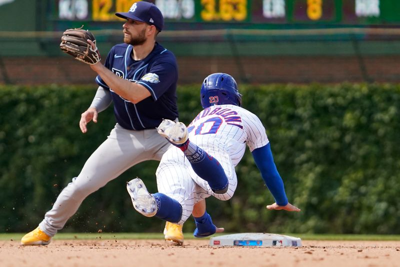 May 31, 2023; Chicago, Illinois, USA; Chicago Cubs second baseman Miles Mastrobuoni (20) steals second base as Tampa Bay Rays second baseman Brandon Lowe (8) takes the throw during the eighth inning at Wrigley Field. Mandatory Credit: David Banks-USA TODAY Sports