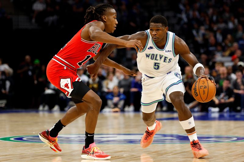 MINNEAPOLIS, MINNESOTA - MARCH 31: Anthony Edwards #5 of the Minnesota Timberwolves drives to the basket against Ayo Dosunmu #12 of the Chicago Bulls in the third quarter at Target Center on March 31, 2024 in Minneapolis, Minnesota. The Bulls defeated the Timberwolves 109-101. NOTE TO USER: User expressly acknowledges and agrees that, by downloading and or using this photograph, User is consenting to the terms and conditions of the Getty Images License Agreement. (Photo by David Berding/Getty Images)