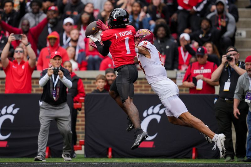 Oct 14, 2023; Cincinnati, Ohio, USA;  Cincinnati Bearcats cornerback Jordan Young (1) breaks up a pass intended for Iowa State Cyclones wide receiver Jayden Higgins (9) in the first half at Nippert Stadium. Mandatory Credit: Aaron Doster-USA TODAY Sports