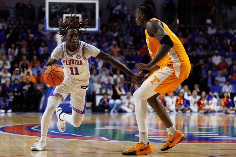 Jan 7, 2025; Gainesville, Florida, USA; Florida Gators guard Denzel Aberdeen (11) drives to the basket at Tennessee Volunteers forward Felix Okpara (34) during the second half at Exactech Arena at the Stephen C. O'Connell Center. Mandatory Credit: Matt Pendleton-Imagn Images