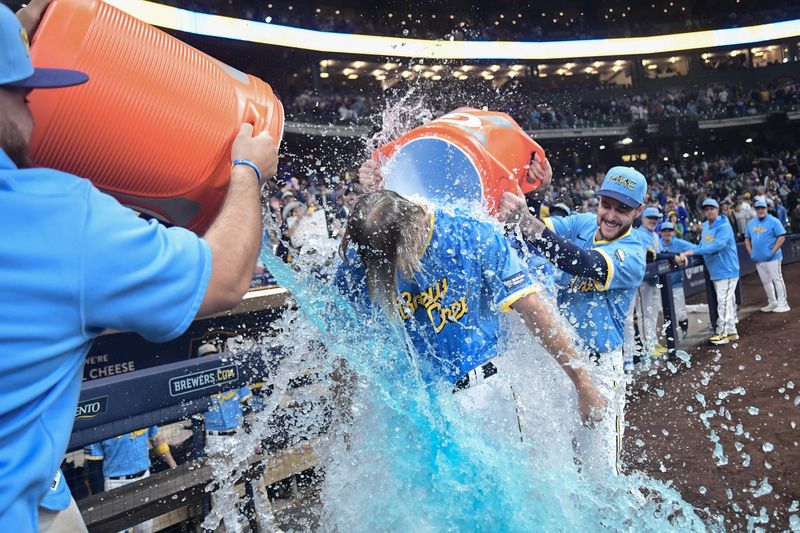 Sep 29, 2023; Milwaukee, Wisconsin, USA; Milwaukee Brewers pitcher Caleb Boushley (57) is dunked after picking up his first win in his first major league game against the Chicago Cubs at American Family Field. Mandatory Credit: Benny Sieu-USA TODAY Sports