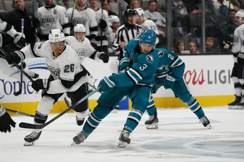 Nov 25, 2024; San Jose, California, USA; San Jose Sharks defenseman Henry Thrun (3) makes a pass against Los Angeles Kings center Akil Thomas (26) in the second period at SAP Center at San Jose. Mandatory Credit: David Gonzales-Imagn Images