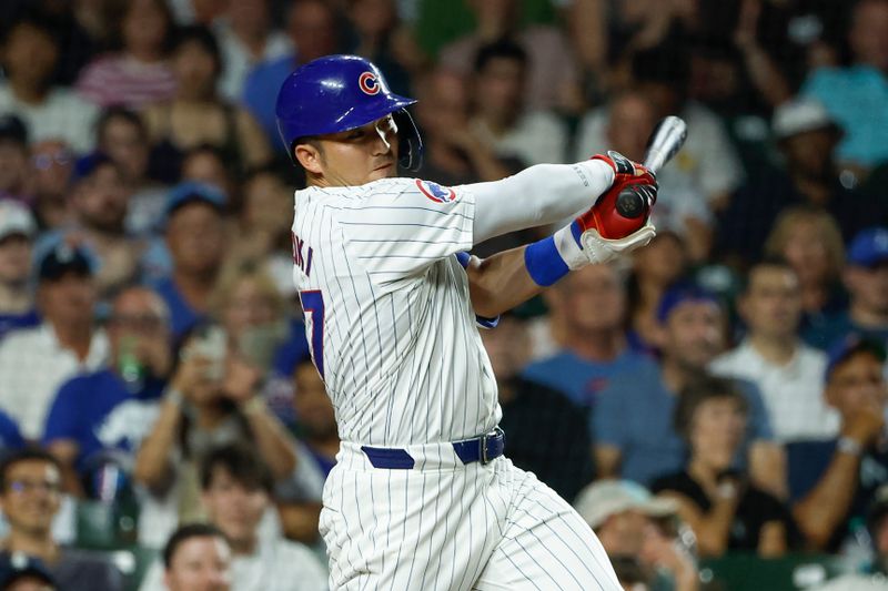 Jun 17, 2024; Chicago, Illinois, USA; Chicago Cubs outfielder Seiya Suzuki (27) singles against the San Francisco Giants during the sixth inning at Wrigley Field. Mandatory Credit: Kamil Krzaczynski-USA TODAY Sports