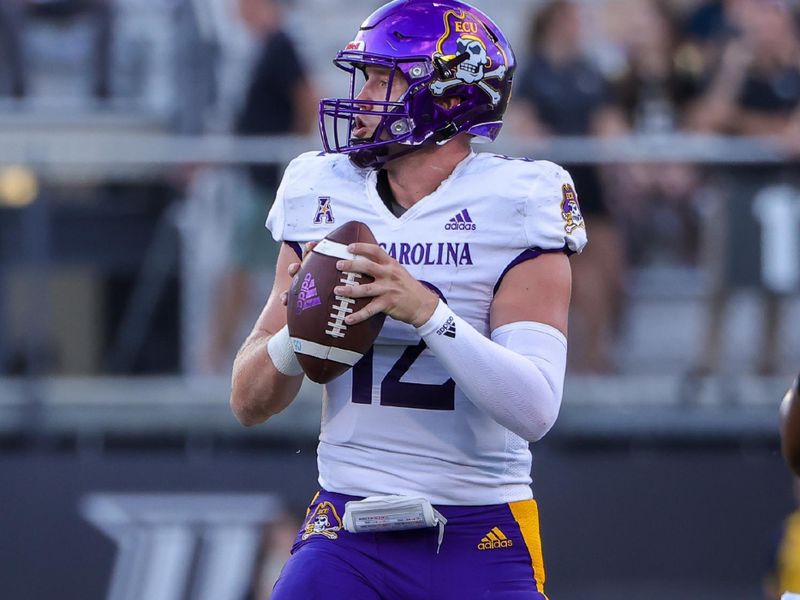 Oct 9, 2021; Orlando, Florida, USA; East Carolina Pirates quarterback Holton Ahlers (12) drops back to pass during the first quarter against the UCF Knights at Bounce House. Mandatory Credit: Mike Watters-USA TODAY Sports