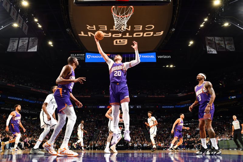 PHOENIX, AZ - NOVEMBER 27: Jusuf Nurkic #20 of the Phoenix Suns goes up for the rebound during the game against the Brooklyn Nets on November 27, 2024 at Footprint Center in Phoenix, Arizona. NOTE TO USER: User expressly acknowledges and agrees that, by downloading and or using this photograph, user is consenting to the terms and conditions of the Getty Images License Agreement. Mandatory Copyright Notice: Copyright 2024 NBAE (Photo by Barry Gossage/NBAE via Getty Images)