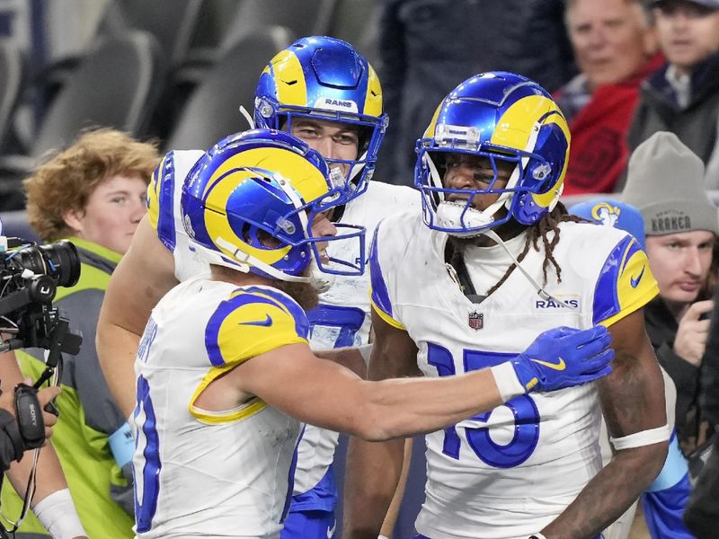 Los Angeles Rams wide receiver Demarcus Robinson, right, is congratulated Cooper Kupp, left, after catching a touchdown pass during overtime of an NFL football game against the Seattle Seahawks in Seattle, Sunday, Nov. 3, 2024. (AP Photo/Stephen Brashear)