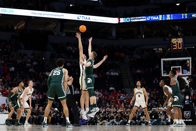 Mar 15, 2024; Minneapolis, MN, USA; Purdue Boilermakers center Zach Edey (15) and Michigan State Spartans center Carson Cooper (15) jump for the opening tip off during the first half at Target Center. Mandatory Credit: Matt Krohn-USA TODAY Sports