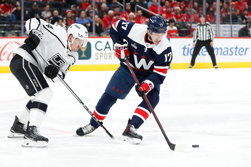 Jan 7, 2024; Washington, District of Columbia, USA; Washington Capitals center Dylan Strome (17) controls the puck in front of Los Angeles Kings defenseman Mikey Anderson (44) during the second period at Capital One Arena. Mandatory Credit: Amber Searls-USA TODAY Sports