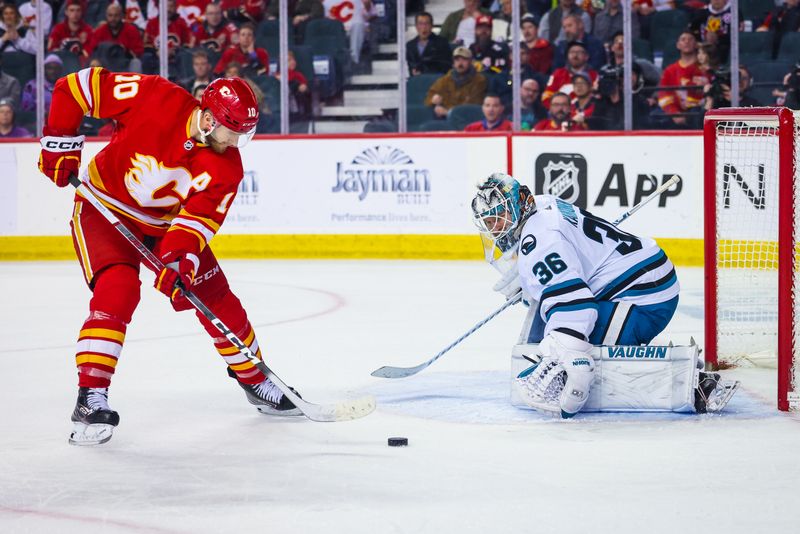 Apr 12, 2023; Calgary, Alberta, CAN; San Jose Sharks goaltender Kaapo Kahkonen (36) makes a save against Calgary Flames center Jonathan Huberdeau (10) during the third period at Scotiabank Saddledome. Mandatory Credit: Sergei Belski-USA TODAY Sports