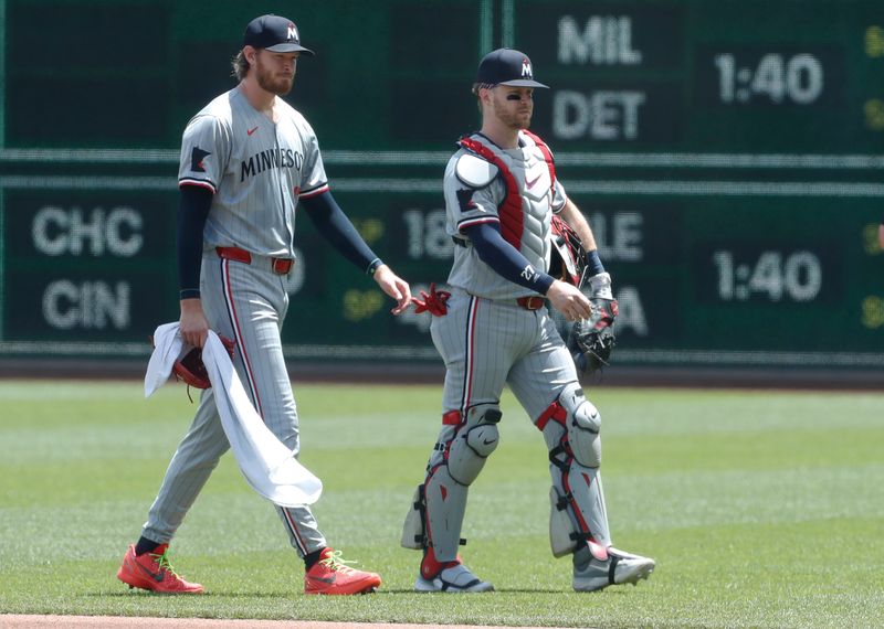 Jun 9, 2024; Pittsburgh, Pennsylvania, USA; Minnesota Twins starting pitcher Bailey Ober (left) and catcher Ryan Jeffers (27) make their way in from the bullpen to play the Pittsburgh Pirates at PNC Park. Mandatory Credit: Charles LeClaire-USA TODAY Sports