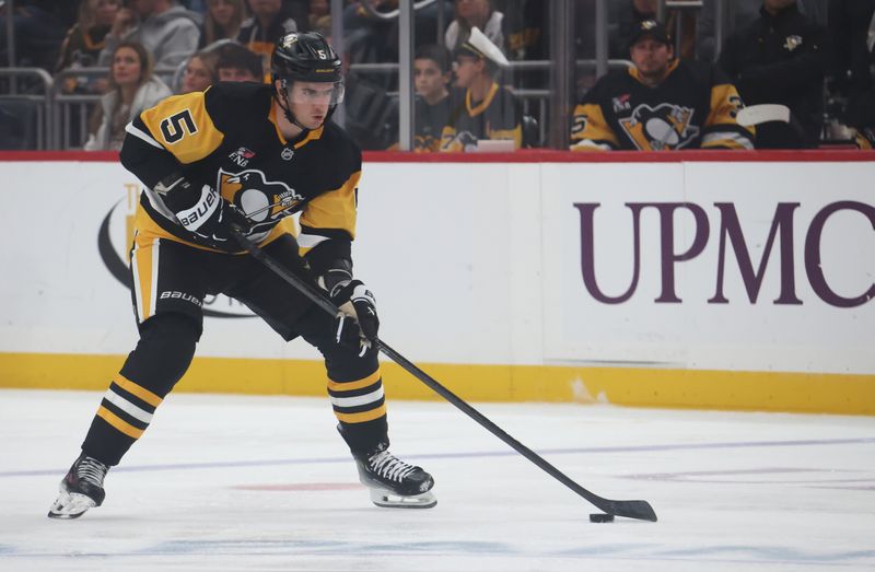 Oct 11, 2025; Pittsburgh, Pennsylvania, USA;  Pittsburgh Penguins defenseman Ryan Shea (5) skates up ice with the puck against the New York Rangers during the first period at PPG Paints Arena. Mandatory Credit: Charles LeClaire-Imagn Images