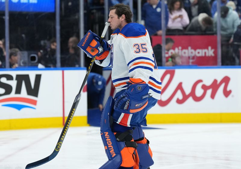 Dec 13, 2025; Toronto, Ontario, CAN; Edmonton Oilers goaltender Tristan Jarry (35) kisses his goal stick before the start of the first period against the Toronto Maple Leafs at Scotiabank Arena. Mandatory Credit: Nick Turchiaro-Imagn Images