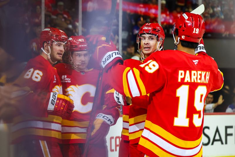 Oct 26, 2025; Calgary, Alberta, CAN; Calgary Flames center Yegor Sharangovich (17) celebrates his goal with teammates against the New York Rangers during the second period at Scotiabank Saddledome. Mandatory Credit: Sergei Belski-Imagn Images