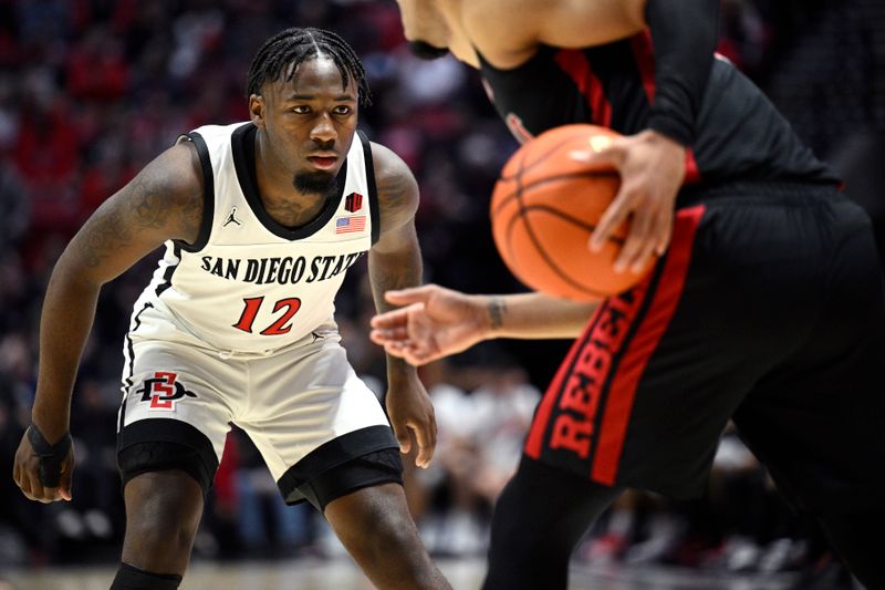 Jan 6, 2024; San Diego, California, USA; San Diego State Aztecs guard Darrion Trammell (12) defends during the first half against the UNLV Rebels at Viejas Arena. Mandatory Credit: Orlando Ramirez-USA TODAY Sports