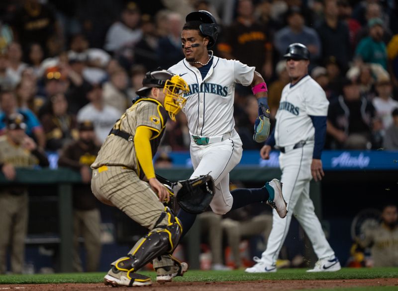 Sep 11, 2024; Seattle, Washington, USA;  Seattle Mariners centerfielder Julio Rodriguez (44) scores a run before San Diego Padres catcher Kyle Higashioka (20) can catch the ball and put on a tag during the third inning at T-Mobile Park. Mandatory Credit: Stephen Brashear-Imagn Images