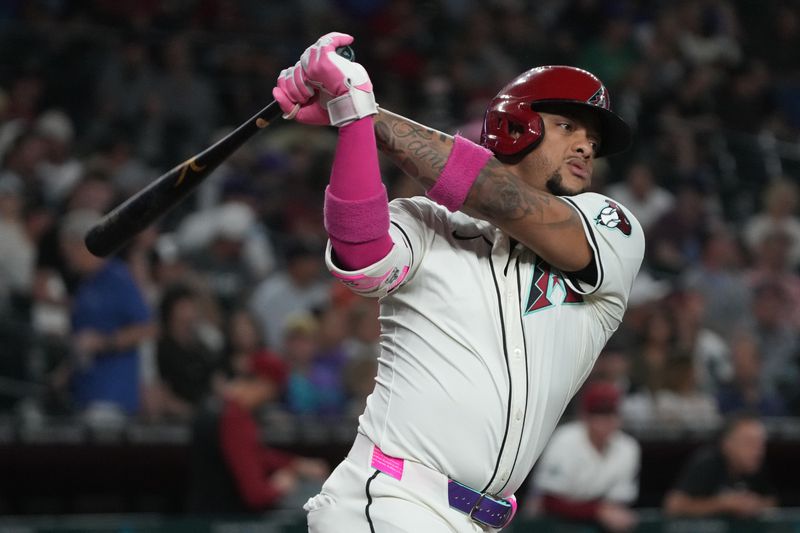 Jun 9, 2025; Phoenix, Arizona, USA; Arizona Diamondbacks second base Ketel Marte (4) hits against the Seattle Mariners in the first inning at Chase Field. Mandatory Credit: Rick Scuteri-Imagn Images