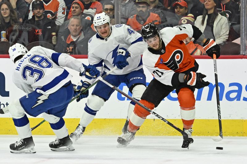 Jan 23, 2024; Philadelphia, Pennsylvania, USA; Philadelphia Flyers right wing Tyson Foerster (71) moves the puck past Tampa Bay Lightning left wing Brandon Hagel (38) during the first period at Wells Fargo Center. Mandatory Credit: Eric Hartline-USA TODAY Sports