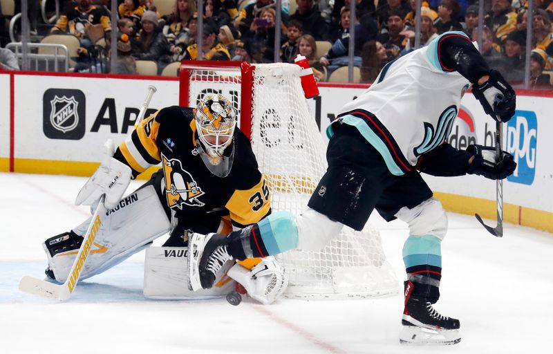 Jan 15, 2024; Pittsburgh, Pennsylvania, USA; Pittsburgh Penguins goaltender Tristan Jarry (35) makes a save  against Seattle Kraken Jaden Schwartz (right) during the second period at PPG Paints Arena. Mandatory Credit: Charles LeClaire-USA TODAY Sports