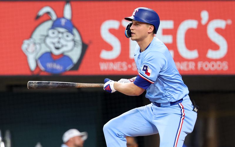 Jul 21, 2024; Arlington, Texas, USA;  Texas Rangers shortstop Corey Seager (5) hits a single during the first inning against the Baltimore Orioles at Globe Life Field. Mandatory Credit: Kevin Jairaj-USA TODAY Sports