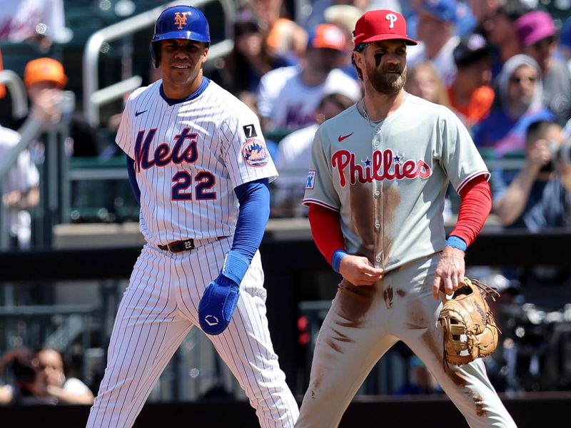 Apr 23, 2025; New York City, New York, USA; New York Mets right fielder Juan Soto (22) leads off first base against Philadelphia Phillies first baseman Bryce Harper (3) during the first inning at Citi Field. Mandatory Credit: Brad Penner-Imagn Images