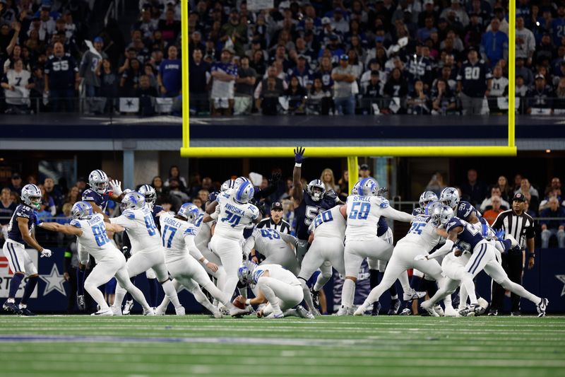 Detroit Lions special teams seen from the back block during an extra point attempt including Jake McQuaide (43) Penei Sewell (58) Taylor Decker (68) Graham Glasgow (60) Benito Jones (94) James Mitchell (82) Anthony Firkser (86) block for an extra point attempt during an NFL football game against the Dallas Cowboys, Saturday, Dec. 30, 2023, in Arlington, Texas. (AP Photo/Matt Patterson)