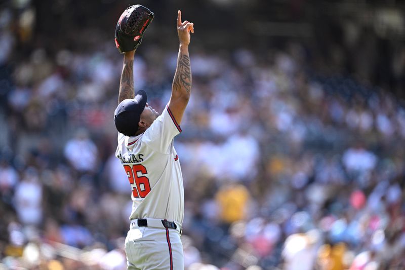 Jul 14, 2024; San Diego, California, USA; Atlanta Braves relief pitcher Raisel Iglesias (26) celebrates on the field after defeating the San Diego Padres at Petco Park. Mandatory Credit: Orlando Ramirez-USA TODAY Sports