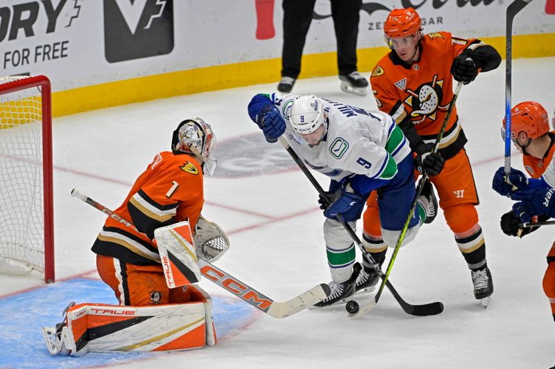 Nov 5, 2024; Anaheim, California, USA;  Vancouver Canucks center J.T. Miller (9) gets in front of Anaheim Ducks center Ryan Strome (16) to score past goaltender Lukas Dostal (1) in the third period at Honda Center. Mandatory Credit: Jayne Kamin-Oncea-Imagn Images