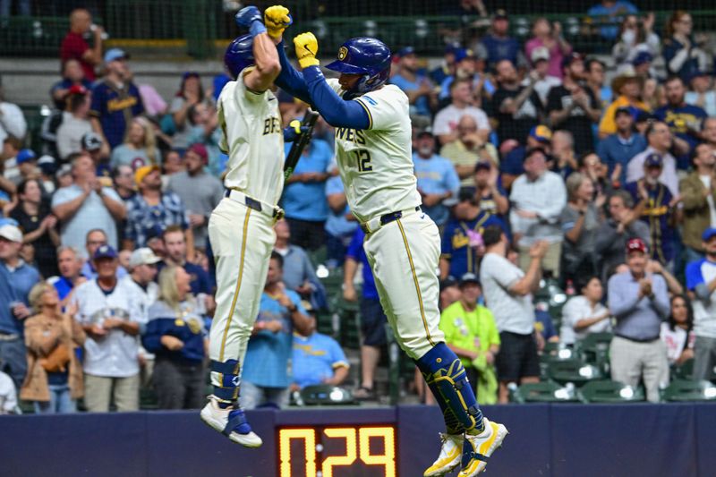 Sep 18, 2024; Milwaukee, Wisconsin, USA; Milwaukee Brewers first baseman Rhys Hoskins (12) celebrates with  right fielder Sal Frelick (10) after hitting a solo home run in the fifth inning against the Philadelphia Phillies at American Family Field. Mandatory Credit: Benny Sieu-Imagn Images