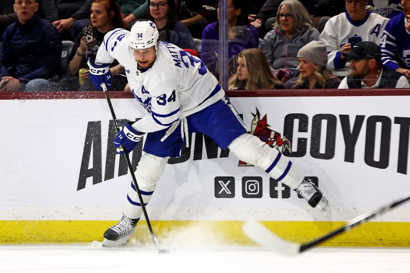 Feb 21, 2024; Tempe, Arizona, USA; Toronto Maple Leafs center Auston Matthews (34) handles the puck during the first period against the Arizona Coyotes at Mullett Arena. Mandatory Credit: Mark J. Rebilas-USA TODAY Sports