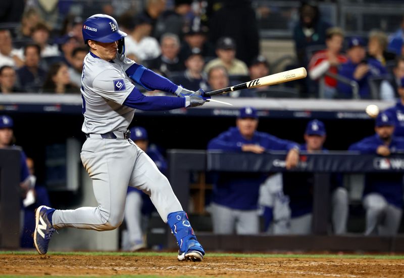 Oct 30, 2024; New York, New York, USA; Los Angeles Dodgers outfielder Tommy Edman (25) singles during the eighth inning against the New York Yankees in game five of the 2024 MLB World Series at Yankee Stadium. Mandatory Credit: Vincent Carchietta-Imagn Images