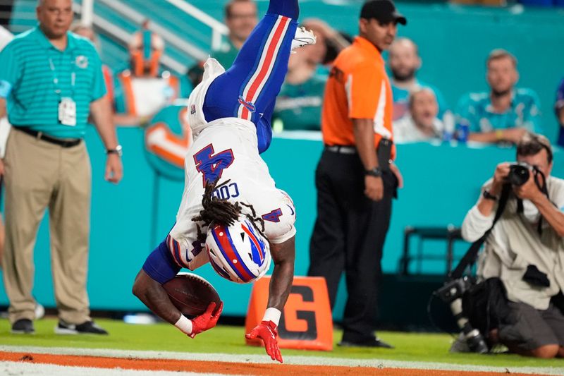 Buffalo Bills running back James Cook (4) scores a touchdown during the first half of an NFL football game against the Miami Dolphins, Thursday, Sept. 12, 2024, in Miami Gardens, Fla. (AP Photo/Rebecca Blackwell)