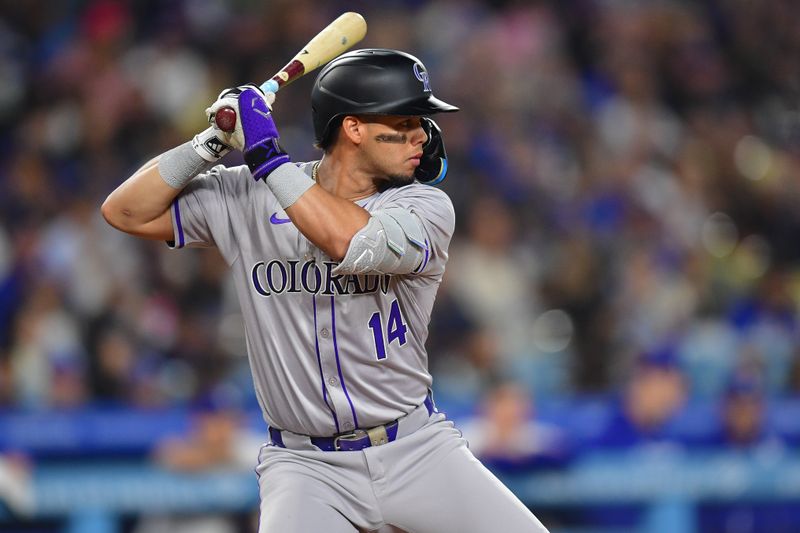 May 31, 2024; Los Angeles, California, USA; Colorado Rockies shortstop Ezequiel Tovar (14) hits against the Los Angeles Dodgers during the seventh inning at Dodger Stadium. Mandatory Credit: Gary A. Vasquez-USA TODAY Sports