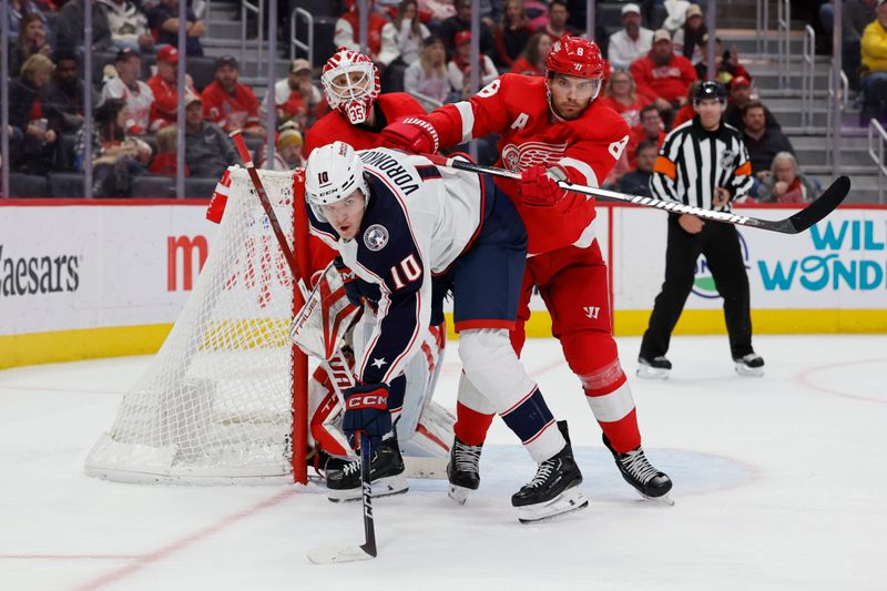 Nov 11, 2023; Detroit, Michigan, USA;  Columbus Blue Jackets left wing Dmitri Voronkov (10) and Detroit Red Wings defenseman Ben Chiarot (8) fight for position in front of goaltender Ville Husso (35) in the third period at Little Caesars Arena. Mandatory Credit: Rick Osentoski-USA TODAY Sports