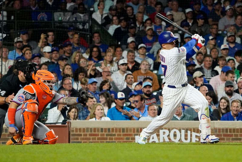 Sep 23, 2025; Chicago, Illinois, USA;  Chicago Cubs outfielder Seiya Suzuki (27) hits a one run single against the New York Mets during the sixth inning at Wrigley Field. Mandatory Credit: David Banks-Imagn Images