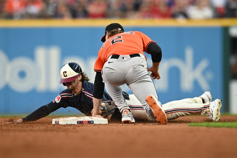 Aug 3, 2024; Cleveland, Ohio, USA; Cleveland Guardians left fielder Daniel Schneemann (10) is caught stealing by Baltimore Orioles shortstop Gunnar Henderson (2) during the fifth inning at Progressive Field. Mandatory Credit: Ken Blaze-USA TODAY Sports