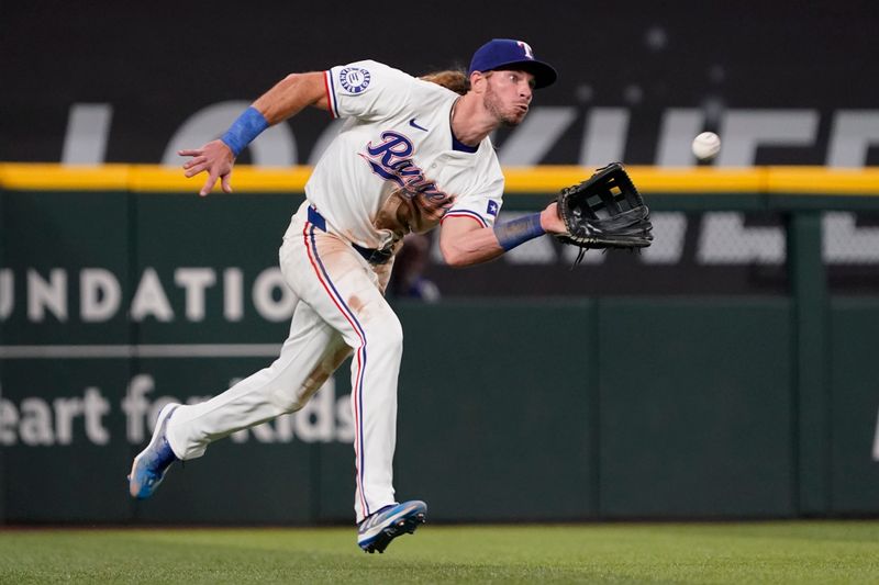 Aug 31, 2024; Arlington, Texas, USA; Texas Rangers right fielder Travis Jankowski (16) makes the running catch during the fifth inning against the Oakland Athletics at Globe Life Field. Mandatory Credit: Raymond Carlin III-USA TODAY Sports