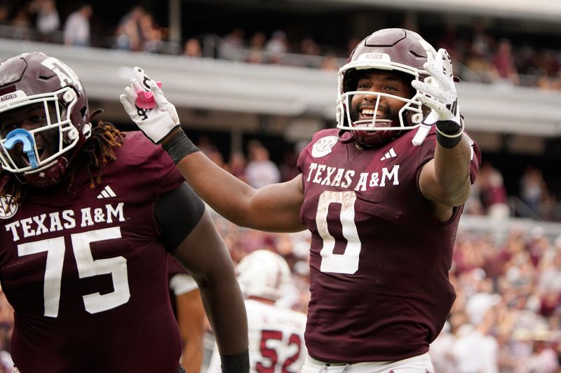 Oct 28, 2023; College Station, Texas, USA; Texas A&M Aggies wide receiver Ainias Smith (0) celebrates a touchdown against the South Carolina Gamecocks during the second quarter at Kyle Field. Mandatory Credit: Dustin Safranek-USA TODAY Sports