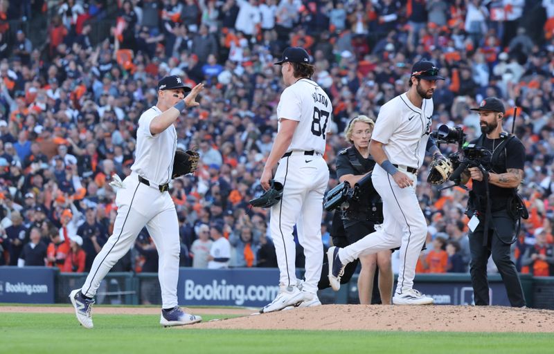 Oct 9, 2024; Detroit, Michigan, USA; Detroit Tigers pitcher Tyler Holton (87) and teammates celebrate after defeating the Cleveland Guardians in game three of the ALDS for the 2024 MLB Playoffs at Comerica Park. Mandatory Credit: David Reginek-Imagn Images