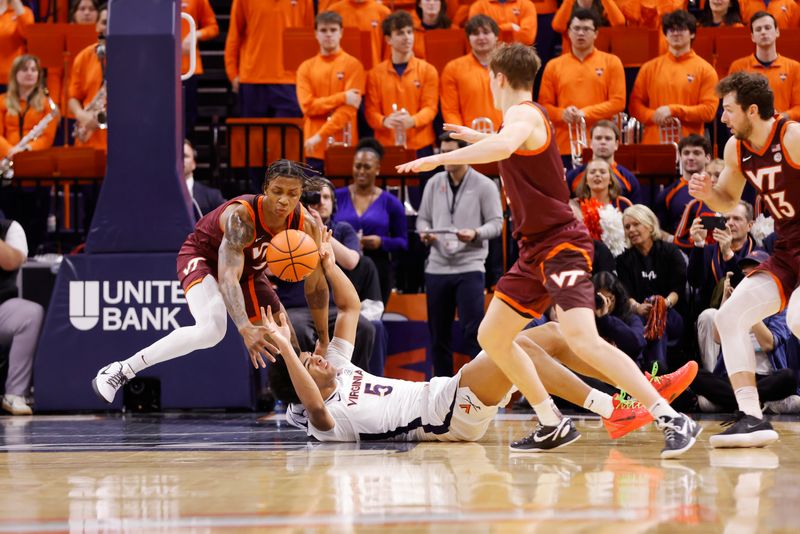 Feb 1, 2025; Charlottesville, Virginia, USA; Virginia Cavaliers forward Jacob Cofie (5) and Virginia Tech Hokies forward Tobi Lawal (1) battles for the ball in the first half at John Paul Jones Arena. Mandatory Credit: Amber Searls-Imagn Images