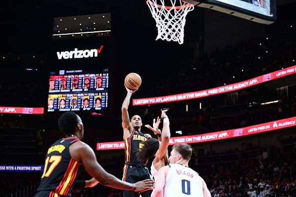 ATLANTA, GA - DECEMBER 11: Dejounte Murray #5 of the Atlanta Hawks shoots the ball during the game against the Denver Nuggets on December 11, 2023 at State Farm Arena in Atlanta, Georgia.  NOTE TO USER: User expressly acknowledges and agrees that, by downloading and/or using this Photograph, user is consenting to the terms and conditions of the Getty Images License Agreement. Mandatory Copyright Notice: Copyright 2023 NBAE (Photo by Adam Hagy/NBAE via Getty Images)