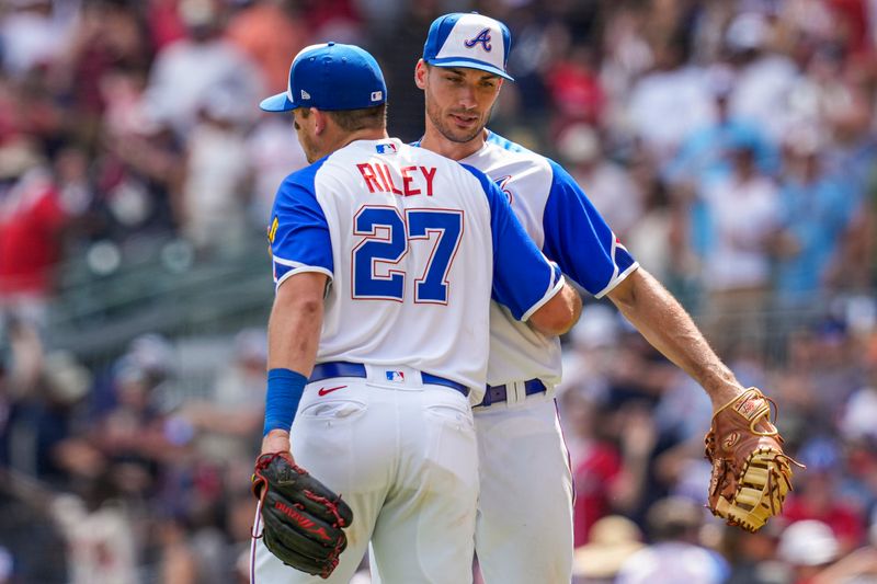 Jul 30, 2023; Cumberland, Georgia, USA; Atlanta Braves third baseman Austin Riley (27) and first baseman Matt Olson (28) react after the Braves defeated the Milwaukee Brewers at Truist Park. Mandatory Credit: Dale Zanine-USA TODAY Sports