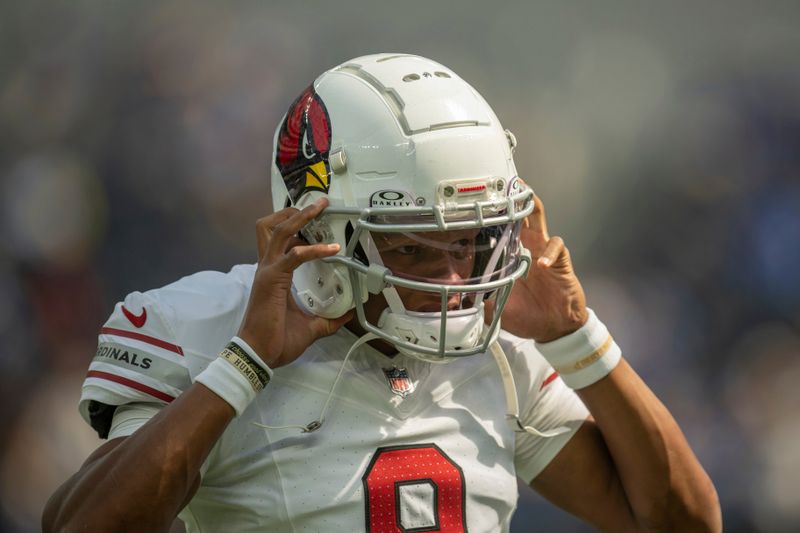 Arizona Cardinals quarterback Joshua Dobbs (9) puts his helmet on before an NFL football game against the Los Angeles Rams, Sunday, Oct. 15, 2023, in Inglewood, Calif. (AP Photo/Kyusung Gong)