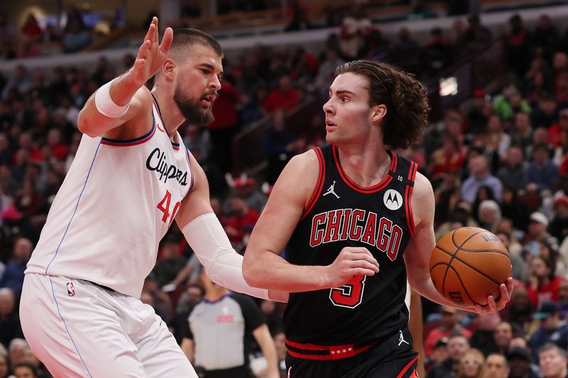CHICAGO, ILLINOIS - FEBRUARY 26: Josh Giddey #3 of the Chicago Bulls dribbles against Ivica Zubac #40 of the LA Clippers during the first half at the United Center on February 26, 2025 in Chicago, Illinois. NOTE TO USER: User expressly acknowledges and agrees that, by downloading and or using this photograph, User is consenting to the terms and conditions of the Getty Images License Agreement.  (Photo by Michael Reaves/Getty Images)